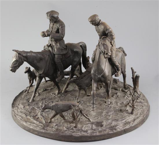 A 19th century Russian cast iron group of two huntsmen and five hounds, width 15in. height 11in.